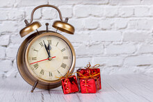 Alarm Clock, Christmas Tree, Gifts Christmas Toys On The Background Of A Brick Wall