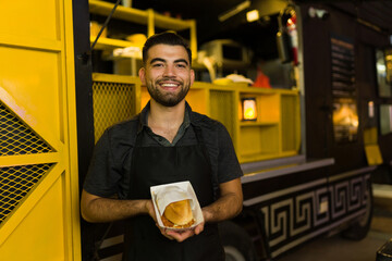 Wall Mural - Portrait of a hispanic cook working at the food truck