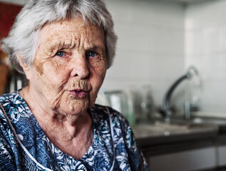 Wall Mural - Ninety two year old white caucasian senior woman at home looking at camera.