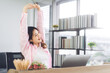 Portrait of young adult southeast business asian woman stretching hand for relax break time at home office
