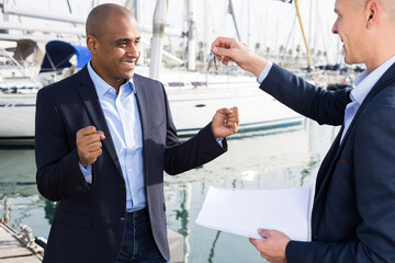 two men in suits buy and sell a yacht in the seaport