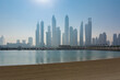 © raresb - Early morning on a private beach in Dubai with clear water and modern buildings