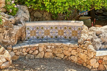 Stone bench near the plants in Scopello Italy, Sicily