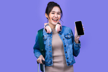 Tourist asian woman in casual clothes hat hold suitcase using mobile cell phone sit isolated on colour background Passenger travel abroad weekends .