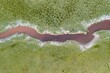 Aerial view of a river stream passing through an open field in Entre Rios, Argentina