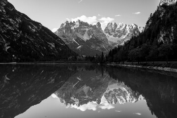 Wall Mural - scenic view of mountain lake against snowcapped Dolomites mountain range