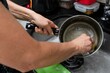 Young woman washing pan and utensils in the kitchen. Hygiene in 