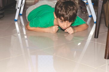 Portrait of a child playing downstairs on a ladder.