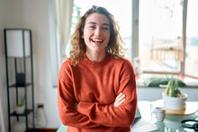 Young Smiling Pretty Lady Standing At Home Looking At Camera, Happy Beautiful Positive Cheerful Professional Woman Laughing In Modern Cozy Apartment Living Room Or In Office, Portrait.