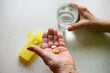 Taking medication - close-up of an elderly person's hand with pills