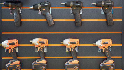 Wall Mural - A professional tool for work, repair and construction in the store. Sale of wired power tools and battery powered equipment in the shop