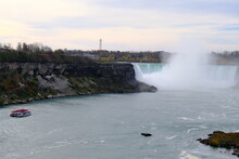 A Ship With Tourists Approaching Niagara Falls In Late Autumn