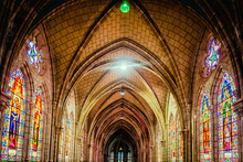 View Of The Basílica Del Voto Nacional Interior Featuring The Arched Ceiling And Stained Glass Windows.