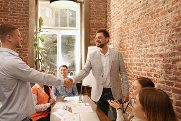 Poster - Office employees shaking hands during meeting at work