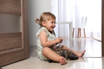 Sticker - Cute little child with adorable pet on floor at home