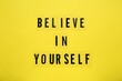 © New Africa - Phrase Believe In Yourself and hearts on yellow background, top view. Motivational quote