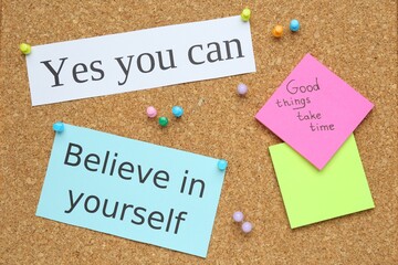 Wall Mural - Notes with motivational quotes pinned to cork board, flat lay