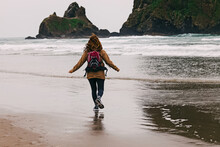 Woman Traveler On Oregon Pacific Coast At Rainy Day. Running On The Beach,