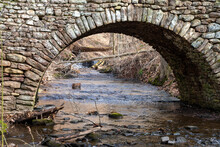 Stone Arch Over A Creek In Winter. High Quality Photo Of A Park In New England.