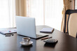 © Лариса Василенко - Close up of comfortable office desk with laptop, mug, tree, stationery and copy space on dark desk
