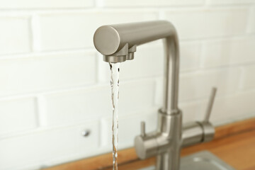 Wall Mural - Kitchen water mixer with flowing water in kitchen room