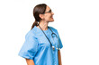 © luismolinero - Middle-aged nurse woman over isolated background laughing in lateral position