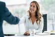 © Westend61 - Happy businesswoman shaking hand with colleague in office