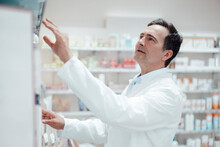 Pharmacist Analyzing Medicines In Store