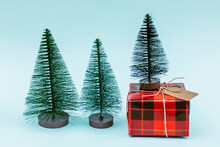 Christmas Trees With Red Gift Box Against Blue Background