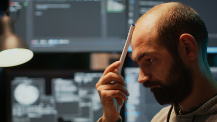pensive database admin brainstorming ideas in office, programming script and source code. thoughtful