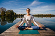 © Westend61 - Woman with eyes closed practicing meditation in front of lake