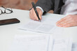 © Westend61 - Hand of businessman signing contract with pen at desk