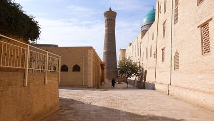 Wall Mural - Autumn, 2022 - Bukhara, Uzbekistan - General plan. Old city of the ancient city. Tourist center of Bukhara. The camera moves to the ancient minaret in the Muslim religious center.