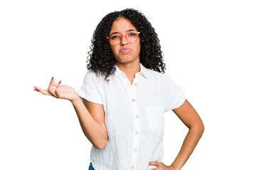 Young cute brazilian woman isolated doubting and shrugging shoulders in questioning gesture.