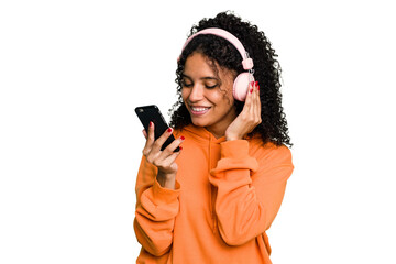 Wall Mural - Young brazilian woman listening to music with headphones isolated