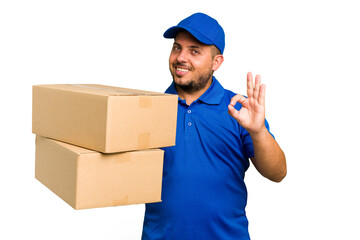 Wall Mural - Delivery caucasian man isolated cheerful and confident showing ok gesture.