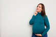 © Asier - Pregnant caucasian woman isolated on white background looking sideways with doubtful and skeptical expression.