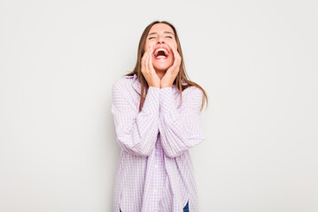 Young caucasian cute woman isolated on white background laughing about something, covering mouth with hands.