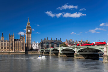 Wall Mural - Big Ben with red buses on bridge over Thames river with boat in London, England, UK