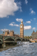 Fototapete - Famous Big Ben with bridge over Thames and tourboat on the river in London, England, UK