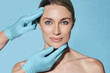 © Peakstock - Ideal shape of woman face for plastic surgeon, reference female face on blue background. Plastic surgery, concept