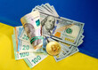 © Natalia - Bitcoin, dollars, euro and hryvnia on the background of the Ukrainian flag.