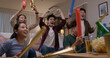 © ChayTee - Group of young adult friend man and woman asia people sit at sofa couch joy night party fun game FIFA world cup live TV at home eat snack bowl drink beer bottle glass jump mad happy win exult face