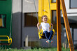 © Ruslan Ivantsov - Happy child sitting on a seesaw at playground on a sunny summer day