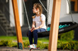 © Ruslan Ivantsov - Happy child sitting on a seesaw at playground on a sunny summer day