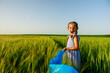 © Ruslan Ivantsov - Little girl with Ukrainian flag in wheat field.