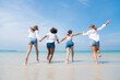© kelvn - Happy friends at beach party runs together on the beach having fun in a sunny day, Beach summer holiday sea people concept