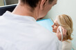 © LIGHTFIELD STUDIOS - blurred physician doing head ultrasound of blonde mature woman in clinic.