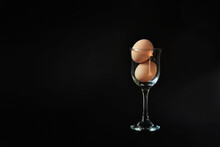 Chicken Egg In A Glass On A Black Background