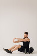 © andriyyavor - Athletic young man doing workouts at home, man doing training, warm up before weight exercise.